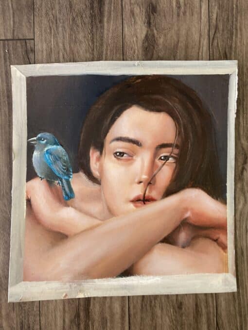 Oil painting of a woman with a blue bird on her shoulder